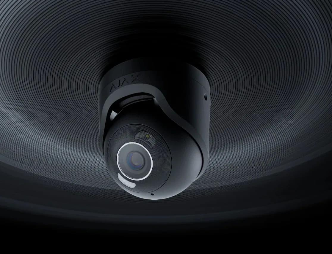 Exterior turret security camera installed under a roof soffit